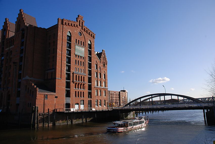 017_18948 der historische Kaispeicher B am Magdeburger Hafen; das denkmalgeschtzte Gebude der Speicherstadt wurde 1879 unter der Leitung der Architekten Hanssen + Meerwein errichtet - es ist das lteste erhaltene Gebude der Hamburger Speicherstadt. Die Barkasse fhrt unter der Magdeburger Brcke Richtung Baakenhafen und Norderelbe. www.christoph-bellin.de