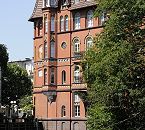 17_21560 Beim Bergedorfer Wasserschloss ist seit 1208 die Bille aufgestaut; das Wasser wurde zum Betreiben einer Kornmhle genutzt und bildete auch den Schlossgraben, der das Schloss geschtzt hat. Blick zum Wehr an der Alten Holstenstrasse - rechts ein dekoratives Backsteingebude mit Erkerturm und Erkergiebel. Mit hell glasierten Steinen werden die Fensterumrandungen des Gebudes hervorgehoben - auf dem Wasser der Bille schwimmen Enten. www.hamburg-fotograf.com