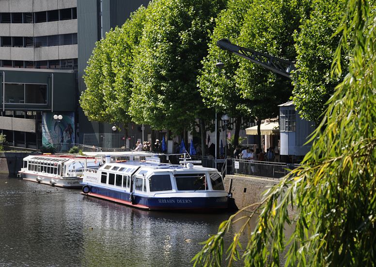 Zwei Ausflugsschiffe der Bergedorfer Schifffahrtlinie liegen an der Kaimauer vom Serrahn - Hafen in der City von Hamburg Bergedorf. Zwischen den Bumen ragt der Arm des historischen Krans aus den Bumen heraus. Der elektrische Drehkran steht unter Denkmalschutz und wurde 1901 bei der Winterhuder Fabrik Nagel & Kaemp   Hafen in der Bergedorfer City - Fahrgastschiffe an der Kaimauer des Serrahns, Drehkran.