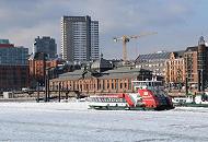 1810 Eine Hafenfhre kommt von den St. Pauli Landungsbrcken und fhrt Richtung Anleger Fischmarkt / Altonaer Fischauktionshalle; die Elbe ist dicht mit Eis bedeckt; das Fhrschiff bahnt sich seinen Weg durch die Eisschollen. Hinter dem histoirschen Auktionsgebude Kontorhuser an der Grossen Elbstrasse. 