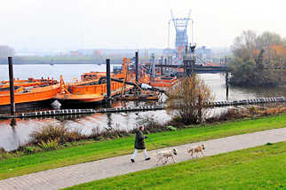 1745 Saugerstation der HPA mit Schuten am Finkenwerder Vorhafen - im Hintergrund die Krananlage der Hamburger Aluminiumwerke.